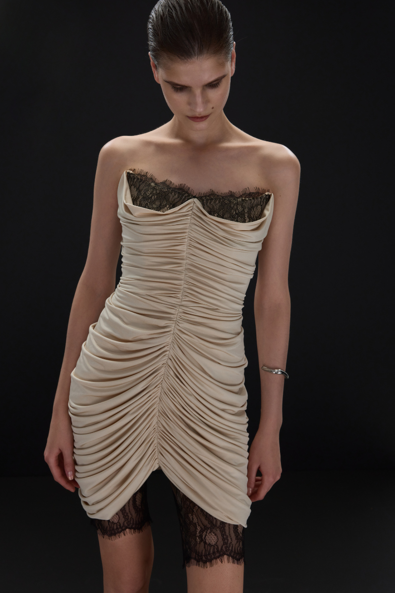 Beige EDEN mini dress by BALYKINA displayed on a hanger, showcasing its simple, elegant design and lightweight fabric.