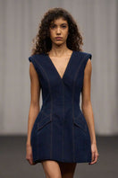 Lili Blanc denim sculpted sleeveless mini dress showcasing a fitted silhouette and sleeveless design on a model.