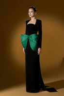 Green Loreli crepe and taffeta gown by I.H.F, featuring elegant fabric and flowing design, displayed on a dress form.