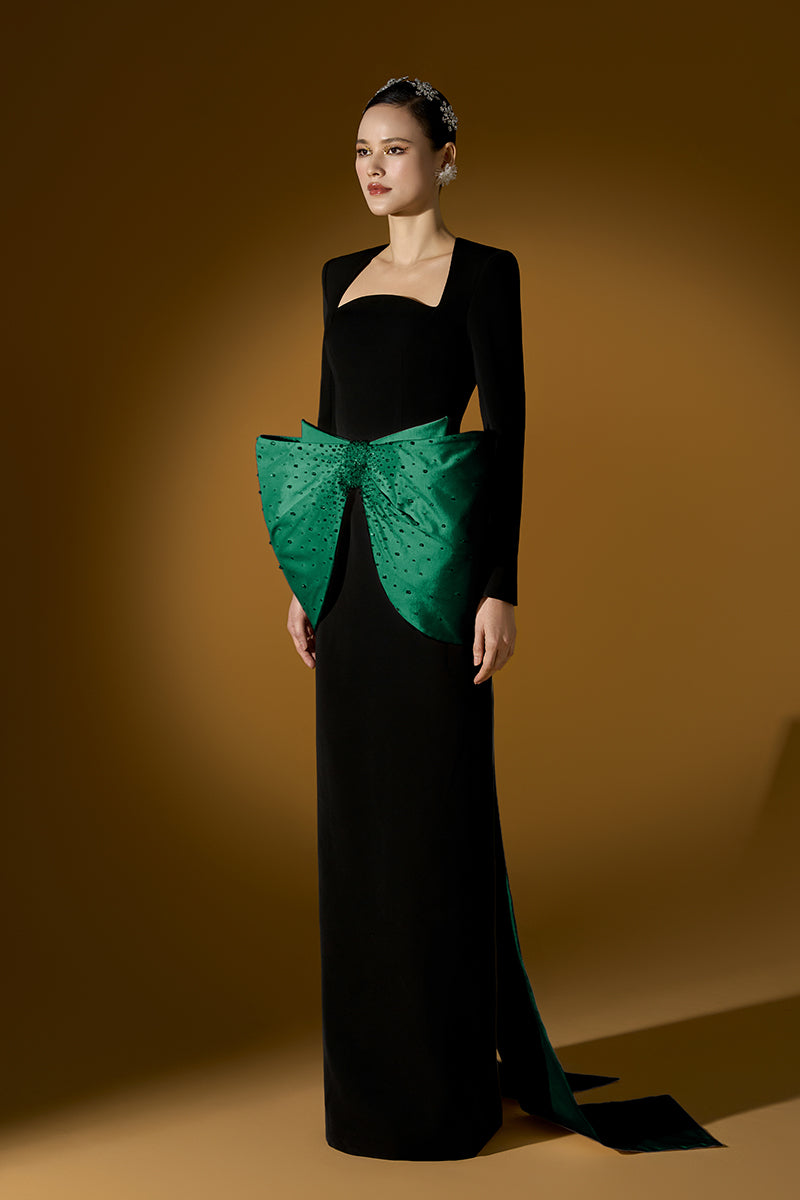 Green Loreli crepe and taffeta gown by I.H.F, featuring elegant fabric and flowing design, displayed on a dress form.