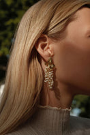 Peracas ivory mini adile earrings shown in a close-up image, featuring small, elegant earring design with a smooth finish.