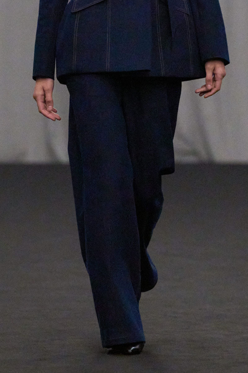 Lili Blanc tailored straight-leg denim trousers, front view showing classic blue jeans with a sleek fit and clean stitching.