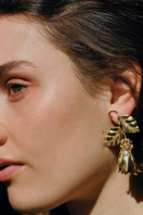 Peracás Persephone earrings featuring elegant dangle design with intricate metalwork and gemstone accents.