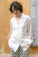 Contrast silk pajama set by Not Just Pajama featuring diamond poodle pattern, soft fabric, and relaxed loungewear style.