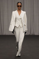 Lili Blanc chic sculpted sleeveless vest in a fitted design, shown in a close-up image highlighting the sleek fabric and tailored fit.