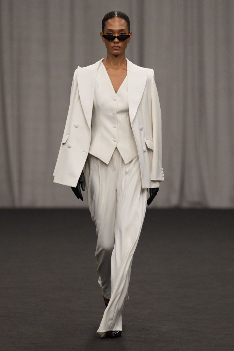 Lili Blanc chic sculpted sleeveless vest in a fitted design, shown in a close-up image highlighting the sleek fabric and tailored fit.