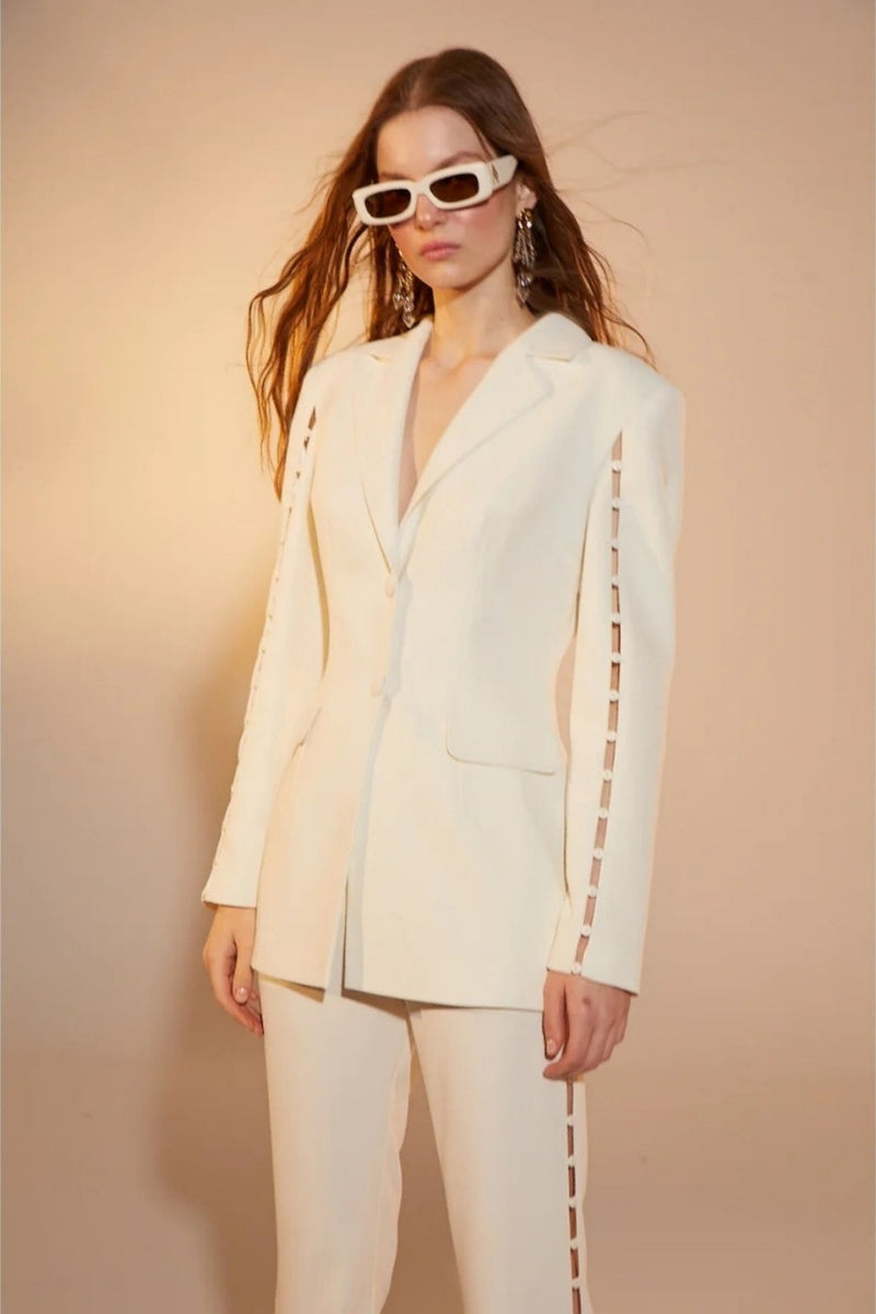 Nazlı Ceren Marylebone crepe flared trousers in vanilla ice color, showcasing stylish, flowy pants with a flared silhouette.