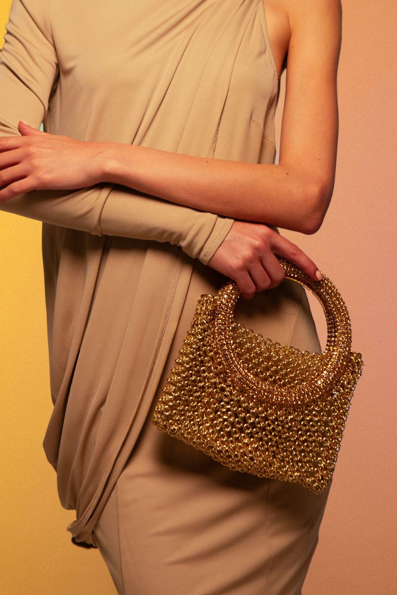 Silvia Gnecchi LA LUNA GOLD shoulder bag with a sleek gold finish, featuring a structured design and top handle.