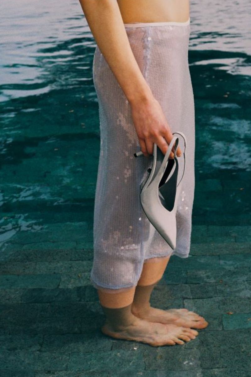 Blue IKINITA water skirt, midi length with flowy fabric, shown on a model, perfect for casual or beachwear styles.