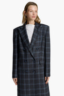 Elegant Charlotte coat by Acaria Studio featuring a tailored design and neutral color, displayed on a hanger.