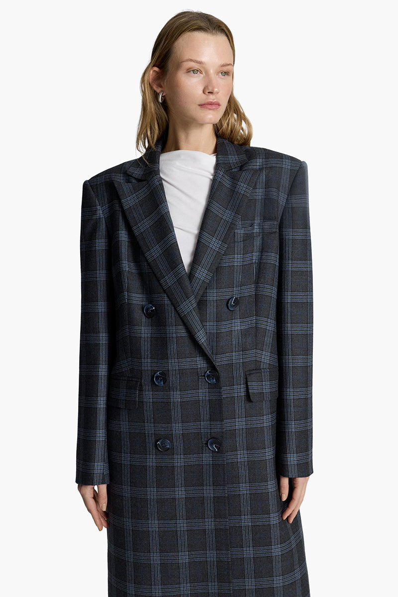Elegant Charlotte coat by Acaria Studio featuring a tailored design and neutral color, displayed on a hanger.