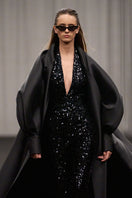 Lili Blanc fluid longline overcoat displayed hanging, showcasing its sleek, elegant design and lightweight fabric.