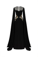 Elegant black velvet satin cape sleeve gown by Tracy Studio, featuring flowing fabric and sophisticated design.