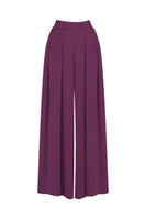 MASTANI Sufia aubergine pants featuring a relaxed fit and stylish design, shown hanging on a clothing rack.