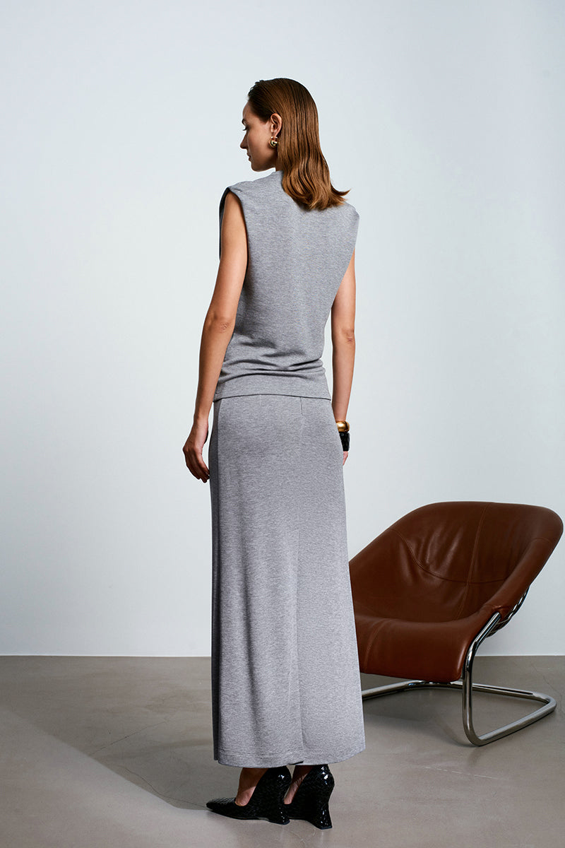 Gray Acaria Studio Lauren top with long sleeves and relaxed fit, shown on a model in a casual setting.