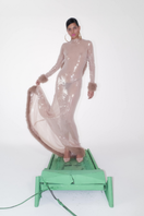 Sudi Etuz sheer sequin gown with faux fur trimmings, elegant long dress featuring shimmering sequins and plush fur accents.