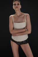 Beige matte silk corset top with straps from BALYKINA, showing close-up of fitted design and smooth fabric texture.