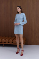 Undress Carmela sky blue tweed mini dress displayed on a mannequin, featuring a fitted silhouette and stylish tweed fabric.