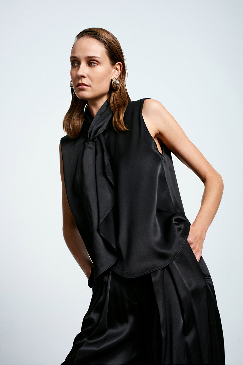 Black satin top from Acaria Studio's Jolly collection, featuring a sleek, elegant design with smooth fabric and stylish fit.