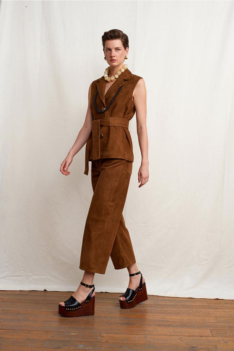 Brown Acaria Studio Terra vest displayed on a model, showcasing the stylish sleeveless vest with a textured fabric.