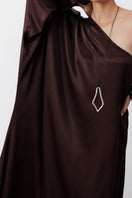 Nazlı Ceren Venus one-shoulder maxi dress in dark chocolate, flowing fabric and elegant design for stylish occasions.