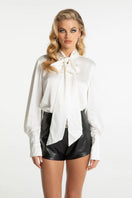 Nana Jacqueline Louisa Top, stylish women's blouse with floral print and ruffled details, displayed on a hanger.