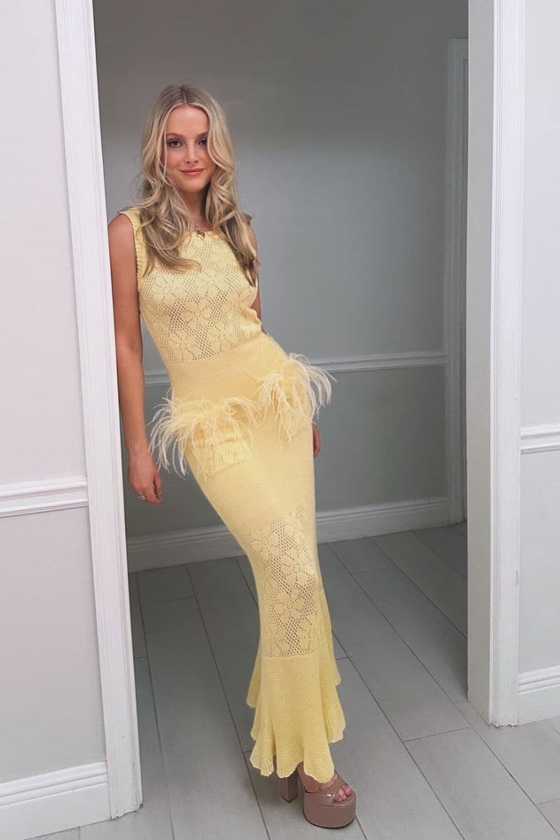 Andreeva knit maxi dress with feather details, flowing silhouette and elegant design, perfect for stylish occasions.
