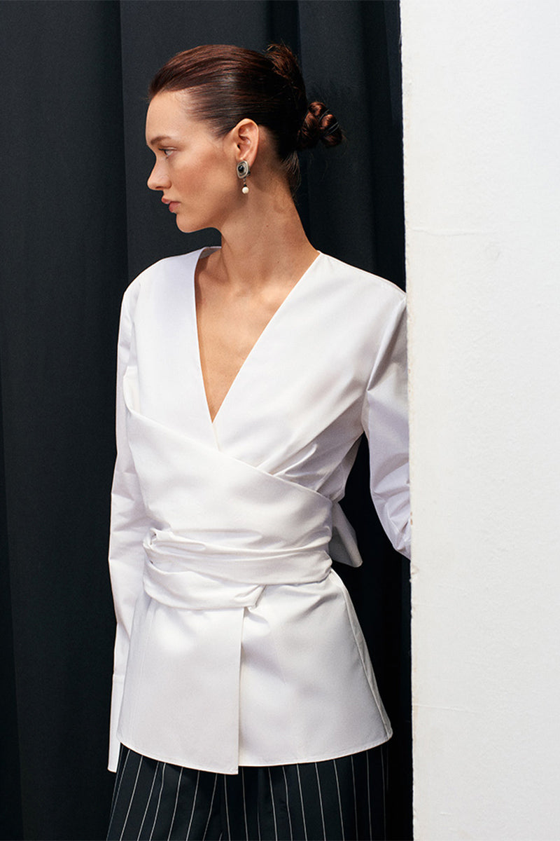 White Journey shirt by Acaria Studio, featuring a classic fit and button-up design, displayed on a hanger.