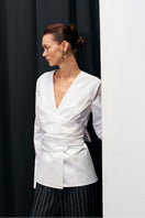 Acaria Studio Journey Shirt displayed on a hanger, featuring a casual button-up design with a relaxed fit and neutral color.