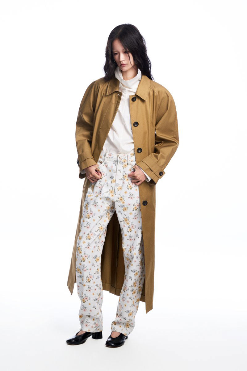 Long brown collared trench coat by Chictopia displayed on a hanger, showcasing its classic design and tailored fit.