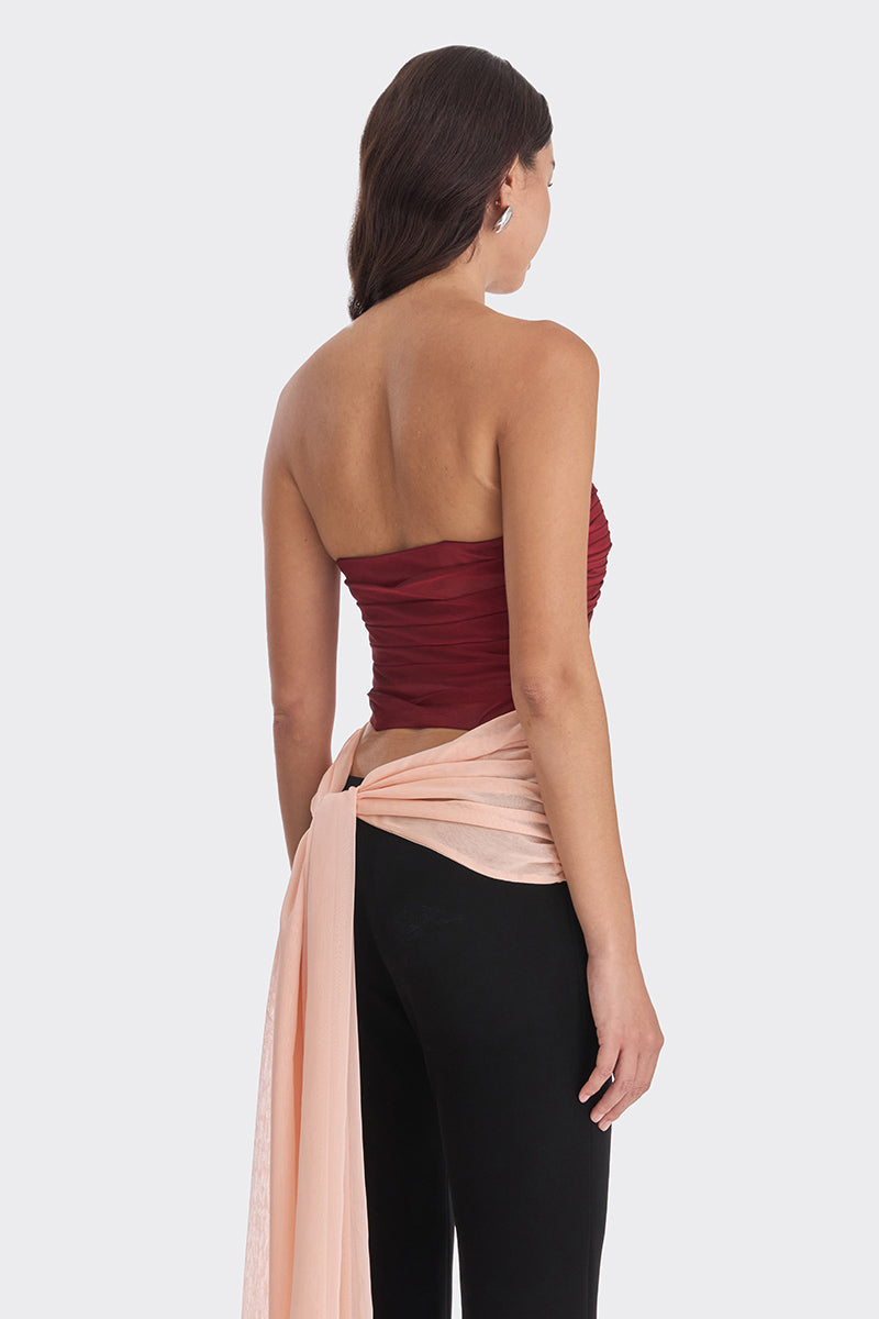Three-tone red and peach bustier top by Stolen Stores featuring warm tones and fitted design.