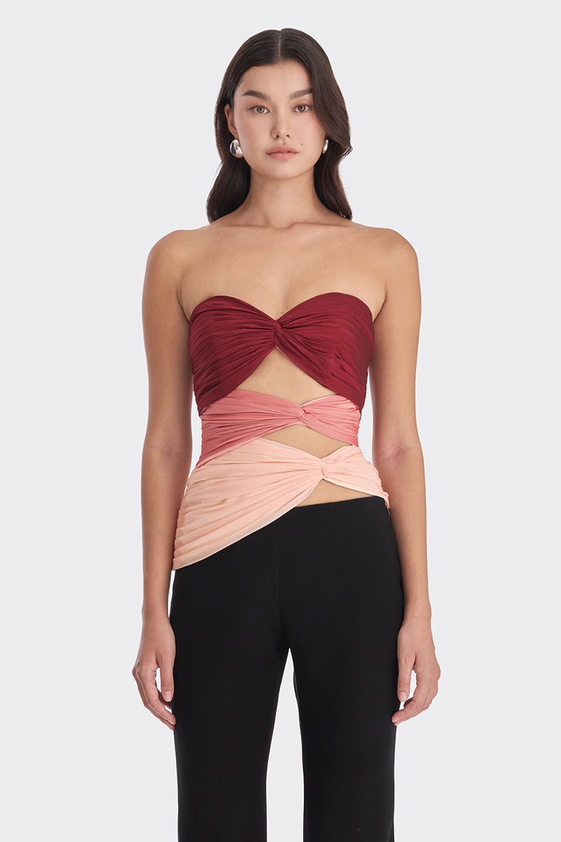 Three-tone warm color bustier top by Stolen Stores, featuring red, peach, and warm hues with a fitted design.