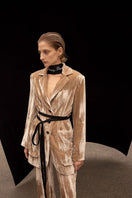 Vaska caramel tailored silk velvet jacket displayed on a hanger, showcasing its luxurious texture and elegant design.