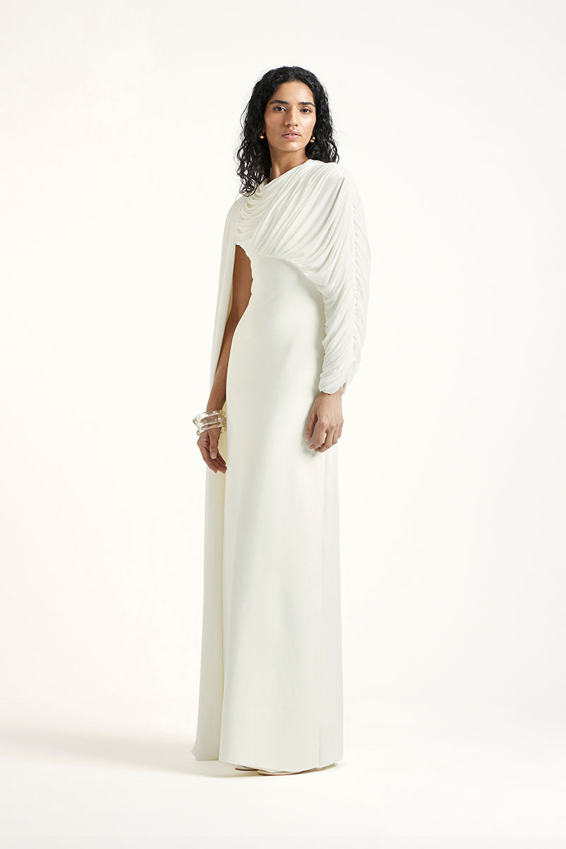 Deme By Gabriella Arienne off-white maxi dress with flowing fabric and elegant design, perfect for casual or formal occasions.