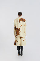 Back view of JINSUN printed wool silk jacket in pale yellow, showcasing its stylish design and smooth fabric texture.