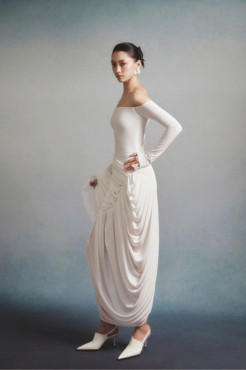 White Plan AURÉLIA draped maxi dress displayed on a hanger with flowing fabric and elegant design.