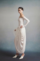 White Plan Aurélia draped maxi dress shown on a model, featuring elegant flowing fabric and a stylish, sophisticated design.