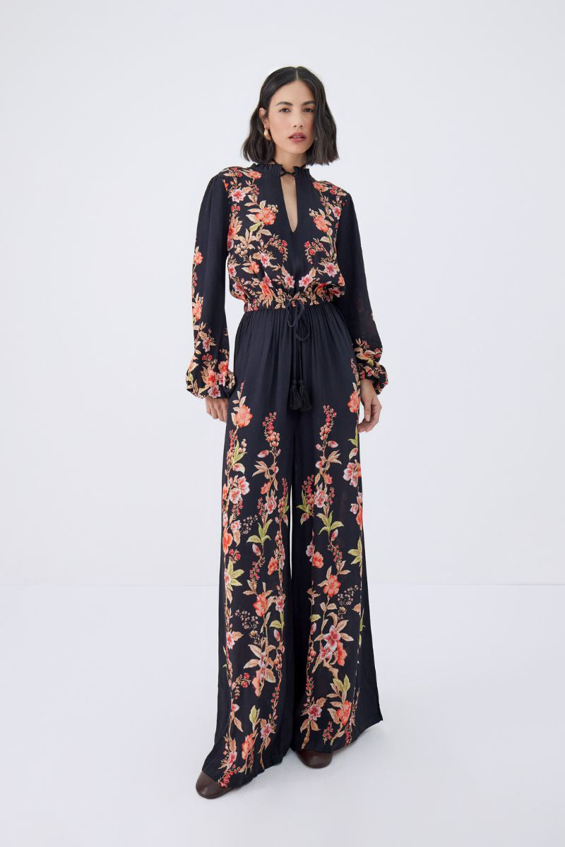 Raishma Viviana jumpsuit shown in black fabric, featuring a fitted bodice and wide-leg pants, stylish and elegant for versatile wear.