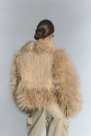 Beige fluffy faux fur jacket by Fortini, stylish and cozy outerwear with a plush texture for cold weather.