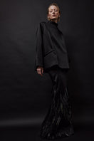 Black embellished mermaid maxi skirt by TAGG, featuring a fitted silhouette, flowing fabric, and decorative details.