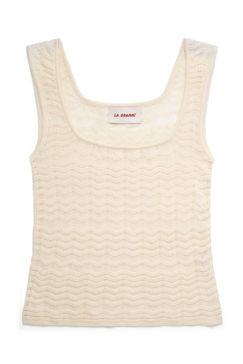 Cream-colored La Granni Marsito top with short sleeves and round neckline, displayed on a hanger.