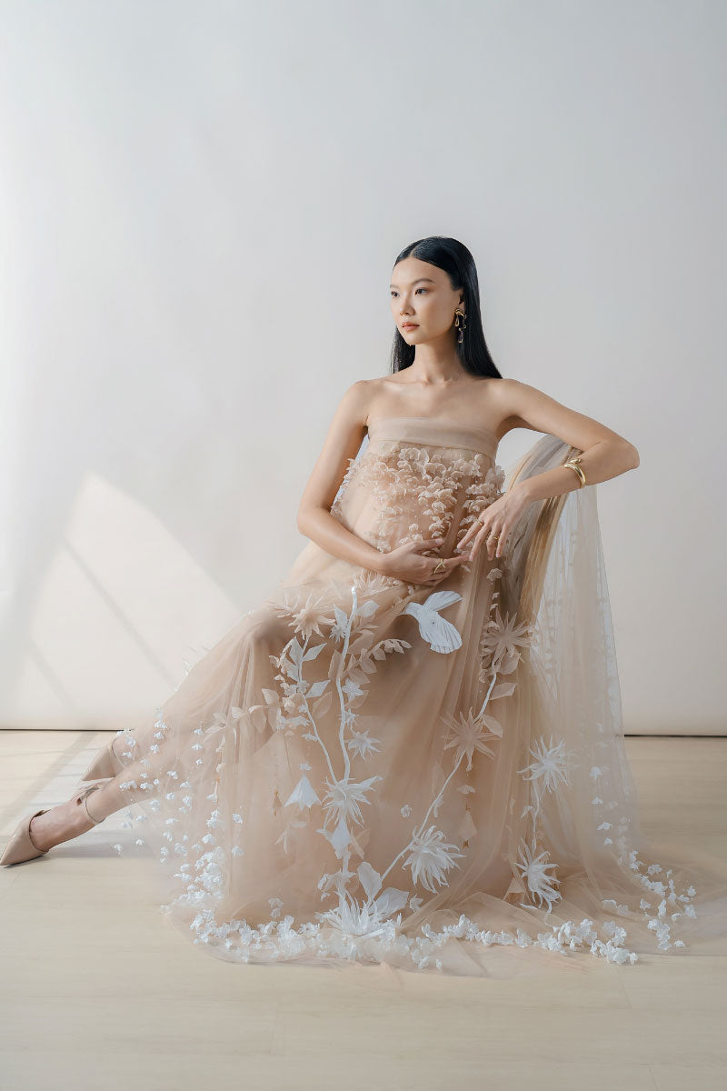 Nude 3D-floral tulle maxi dress by DOC BAN featuring intricate floral embroidery and flowing fabric for elegant style.