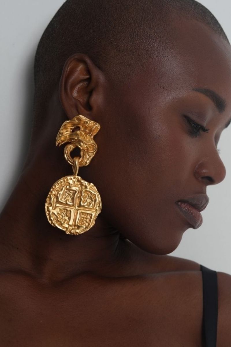 Anatina medallion earrings with intricate circular designs and dangling accents, showcasing elegant jewelry craftsmanship.