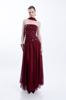 Elegant burgundy Alina gown by LEDIEL, featuring a flowing fabric and detailed design, perfect for formal occasions.
