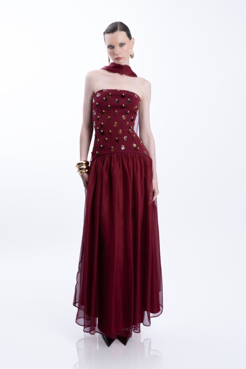Elegant burgundy Alina gown by LEDIEL, featuring a flowing fabric and detailed design, perfect for formal occasions.