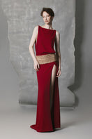 Phan Huy wine-red slit gown featuring a wide back strap, elegant design, and flowing fabric, perfect for formal occasions.