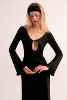 OvertheSea black insomnia midi dress displayed on a hanger, showcasing its sleek design and elegant length.