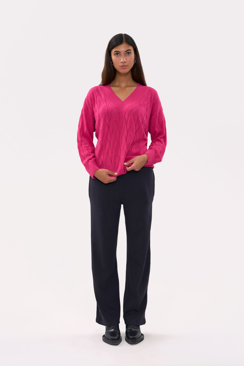 Bright pink oversized V-neck sweater by La Granni featuring a relaxed fit and soft knit fabric.