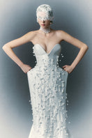 White Plan Christopher gown with elegant design, featuring a flowing silhouette and intricate details perfect for formal occasions.