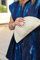 Adriana Castro mini leather clutch in gold with sleek design and compact shape, perfect for elegant evening accessories.